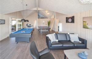 a living room with a couch and a pool table at Lovely Home In Grenaa With Sauna in Grenå