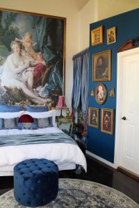 a bedroom with a large painting on the wall at Angel Place Robertson in Robertson
