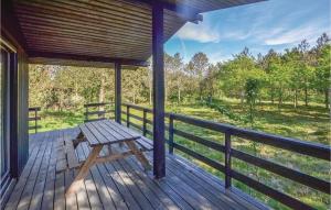 a wooden porch with a picnic bench on a deck at Three-Bedroom Holiday Home In Hurup Thy in Sindrup