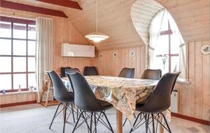 a dining room with a table and chairs at Amazing Home In Ringkbing With Kitchen in Klegod