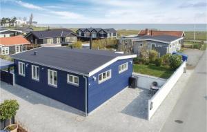 an aerial view of a blue house in a suburb at Awesome Home In Nyborg With Wifi in Nyborg