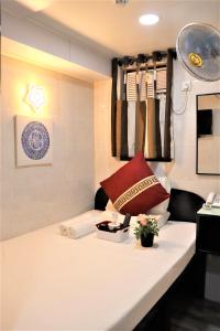 a room with a bed with a white table at The One Inn in Hong Kong