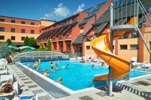 a swimming pool with a slide in a hotel at OREA Resort Panorama Moravský kras in Blansko