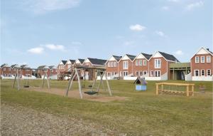 a park with swings and a playground with houses at Lejlighed 190 in Rømø +24 photos