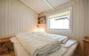 a large white bed in a room with a window at 3 Bedroom Awesome Home In Ebeltoft in Ebeltoft