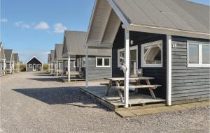 a house with a picnic table in front of it at Hytte 21 in Thyborøn