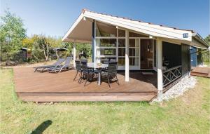 a wooden deck with a table and chairs on it at Holiday Home Ingerslevvej Gørlev Vi in Gørlev
