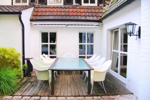 een tafel en stoelen op een houten terras bij Villa EMG in Emsdetten