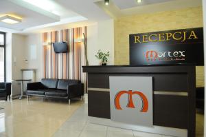 a reception area of a hotel lobby with a sign at Hotel Martex in Płońsk