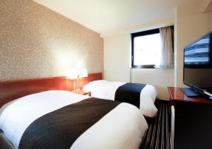 Postel nebo postele na pokoji v ubytování APA Hotel Tokyo Ojima