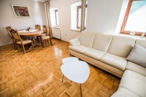 a living room with a couch and a table at Holiday Home Mountain View in Ljubno