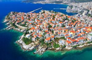 an aerial view of a town on an island in the water at Zero Spot in Kavala