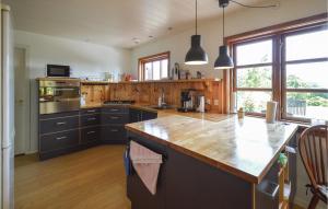 a kitchen with wooden counters and a counter top at Stunning Home In Torrig L With House Sea View in Torrig