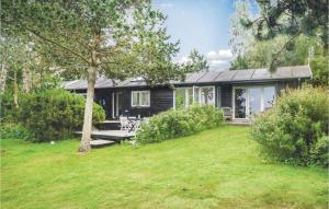 a small house with a picnic table in a yard at Stunning Home In Kalundborg With Kitchen in Kalundborg