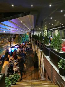 a group of people sitting at tables in a restaurant at International Palace in Veles