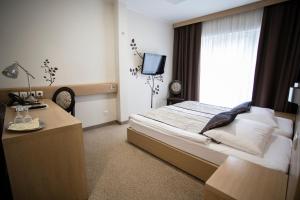 Postel nebo postele na pokoji v ubytování Hotel Mangart