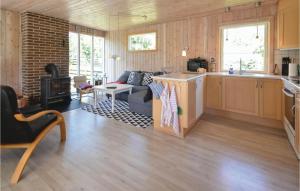 uma cozinha e sala de estar com um sofá e um fogão em Nice Home In Thyholm With 3 Bedrooms And Wifi em Thyholm