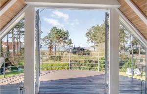 an open door with a view of a deck at Holiday Home Mimosavej Ebeltoft Iii in Ebeltoft +25 photos