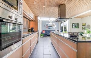 a large kitchen with a long counter in a room at Holiday Home Mimosavej Ebeltoft Iii in Ebeltoft