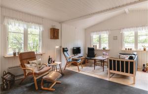 una sala de estar con paredes y ventanas blancas. en Nice Home In Nex With Wifi en Balke