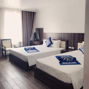 Säng eller sängar i ett rum på Khách sạn Hải Quân - The Marine Hotel