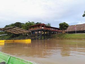 a building is surrounded by water with at Hospedaje y tours Reina Arriera amazonas colombia in Macedonia