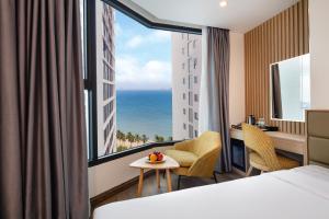 a hotel room with a view of the ocean at Lucky Sun Hotel in Nha Trang