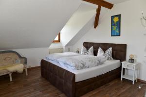 a bedroom with a large bed in a attic at Landhaus Lehhof in Atzenzell