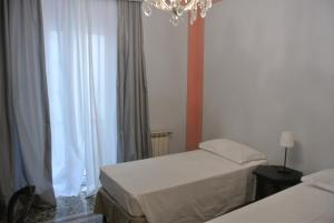 Postel nebo postele na pokoji v ubytování Palazzo Zecchino B&B
