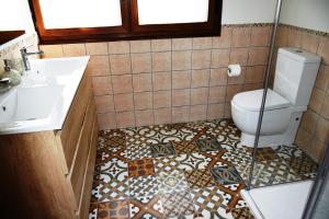 a bathroom with a toilet and a sink at O Mencer do Camiño in Cee +14 photos