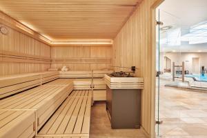 a sauna with wood paneling and a swimming pool at Sunday Hotel Wiesbaden Niedernhausen Apartments in Niedernhausen