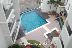 an overhead view of a swimming pool in a building at Taiping Centre Point Suite 10 by BWC in Taiping