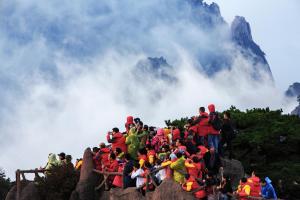 a group of people standing on top of a mountain at Old Street Xi'an Inn (Free Pick up Service) in Huangshan