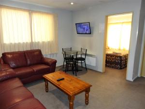 a living room with a couch and a table at Bealey Avenue Motel in Christchurch