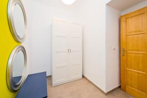 a room with a door and a mirror at Budget Apartment in Prague