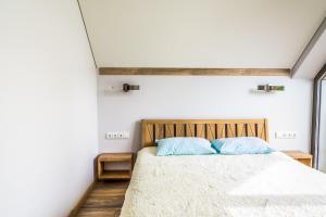 a bedroom with a bed with blue pillows at Golden Beach in Šventoji