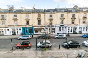 a group of cars parked in front of a building at Luxury Apartments - 10 Royal Parade in Cheltenham