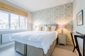 a bedroom with a large bed and a window at Luxury Apartments - 10 Royal Parade in Cheltenham