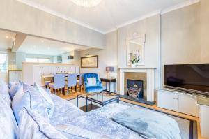 a living room with a couch and a fireplace at Luxury Apartments - 10 Royal Parade in Cheltenham