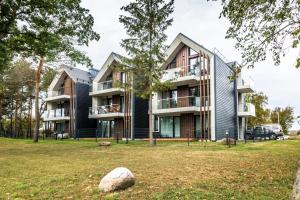 a house in a park with a rock at Golden Beach in Šventoji