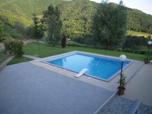 a swimming pool in the middle of a yard at B&B Il Pozzo Di Celle in Vernio