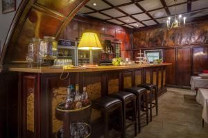 a bar with leather stools in a restaurant at Hotel Deutsches Haus Mittweida in Mittweida