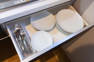 a set of plates and utensils in a drawer at KIKI HOTEL in Kanazawa