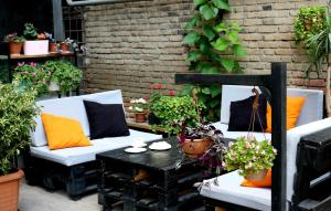 a patio with two couches and a table with plants at Vere Side Hotel in Tbilisi City