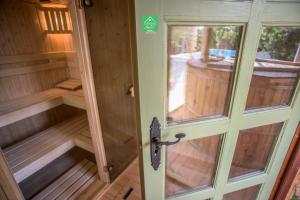 a inside of a sauna with a door at Green Chalet in Veresegyház
