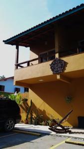 a building with a flower pot on the side of it at Camburi suites in Camburi