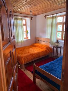 a bedroom with two beds and a window at Hotel Grabova in Grabova e Sipërme