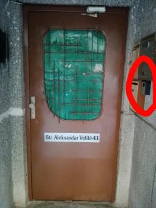 a brown door with a sign in front of it at INFINITY Blue 3 in Burgas