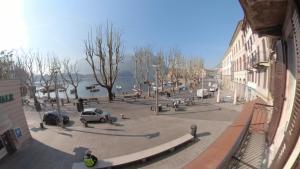 a city street with cars parked on the street at La Casa sul Lago Lecco in Lecco