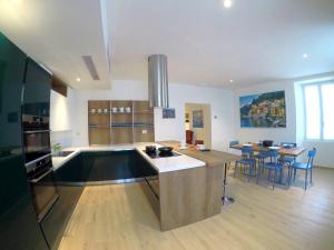 a kitchen with a large island in the middle at La Casa sul Lago Lecco in Lecco